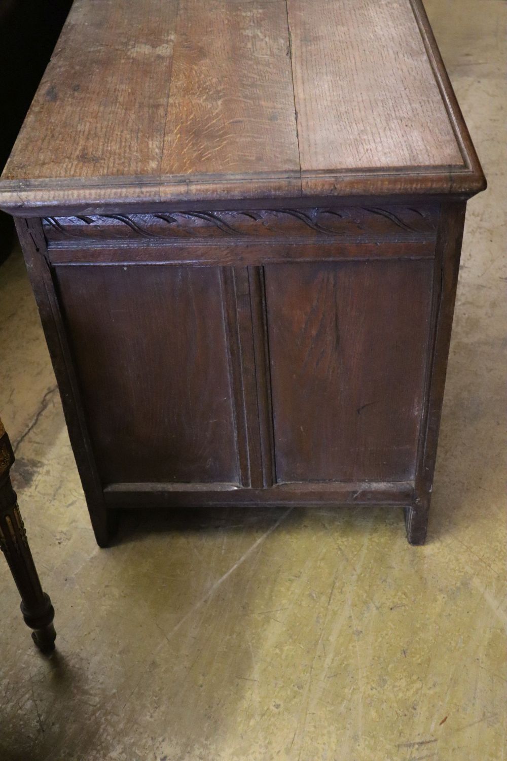 A 17th/18th century inlaid oak coffer with panelled front and planked top, width 145cm depth 53cm height 66cm